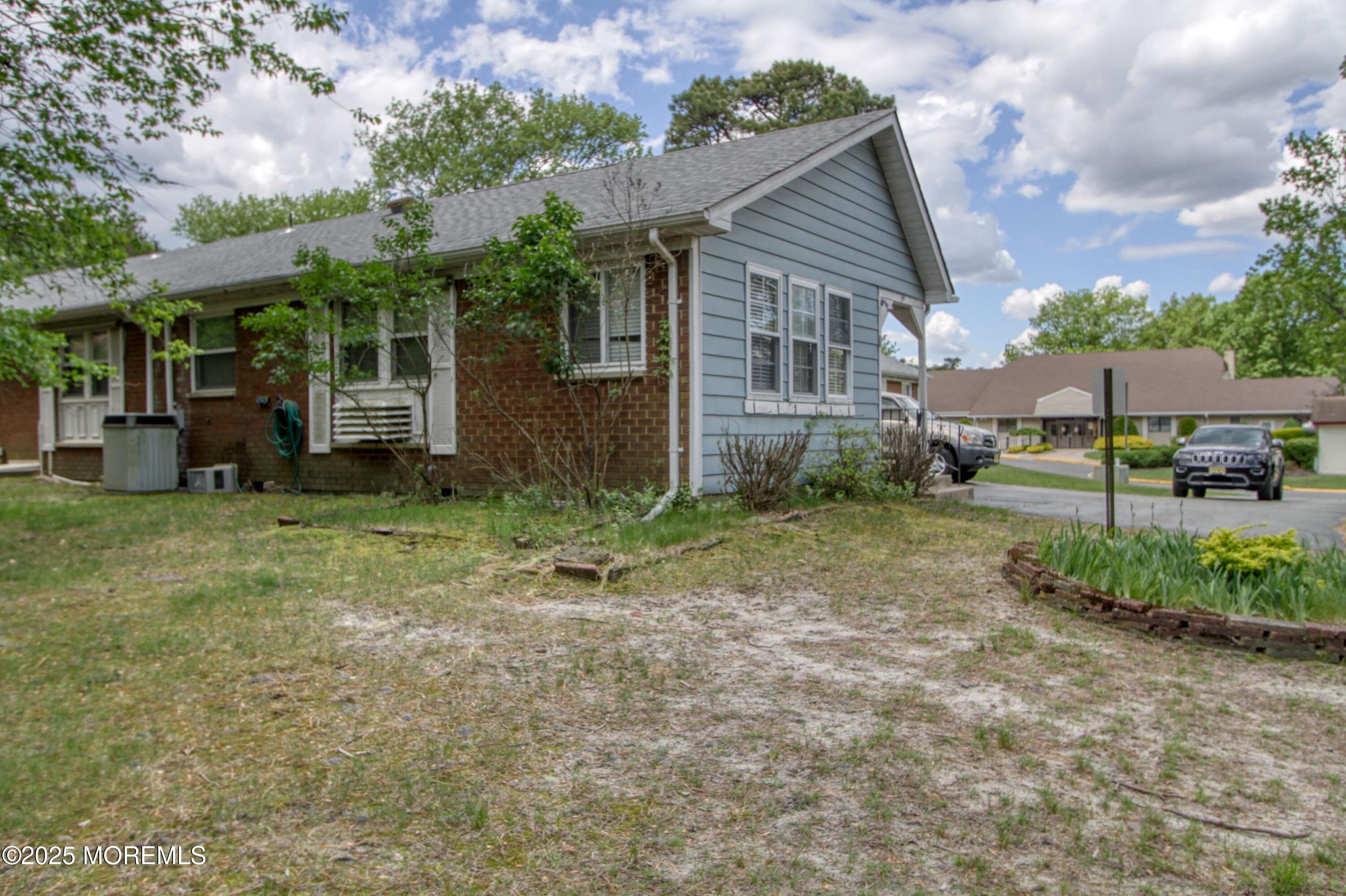 18 Moccasin Drive, Unit D Whiting, NJ 08759 - Photo 15 of 15 a view of a house with a yard and sitting area