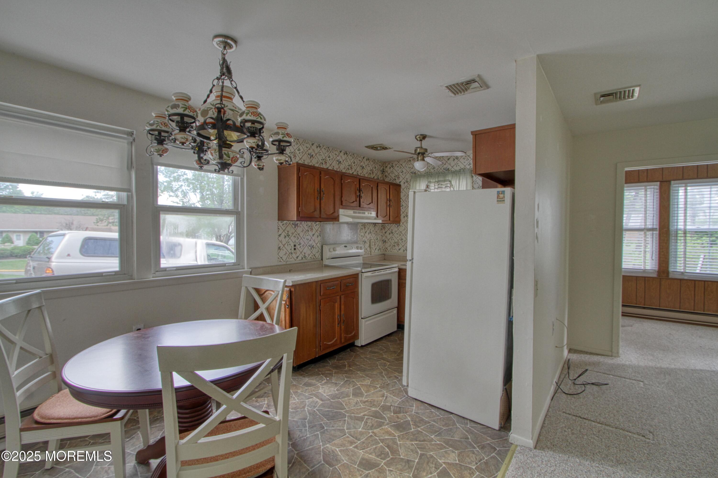 18 Moccasin Drive, Unit D Whiting, NJ 08759 - Photo 4 of 15 a kitchen with stainless steel appliances granite countertop a sink stove and refrigerator