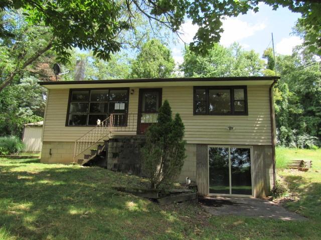 1410 Brownfield Road Uniontown, PA 15401 - Photo 1 of 23 a house that has a tree in front of the house