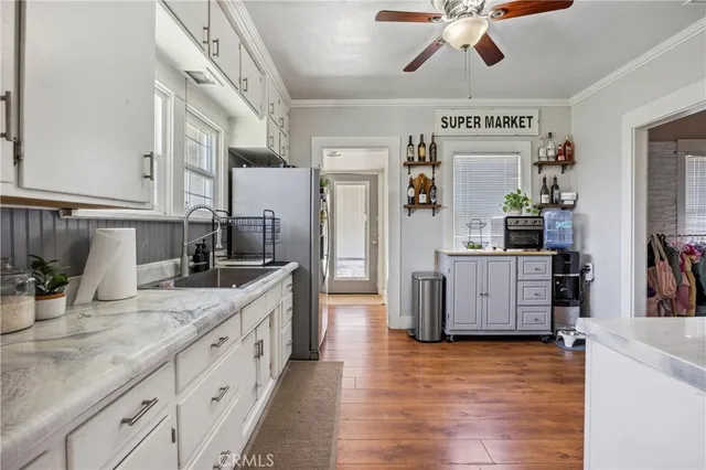 a kitchen with stainless steel appliances granite countertop a sink and cabinets