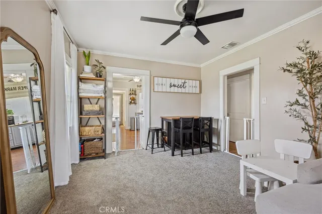 a living room with furniture and a ceiling fan