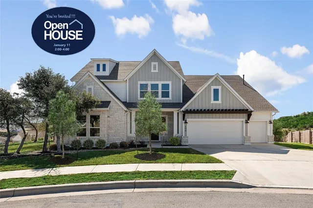 a front view of a house with a garden and garage