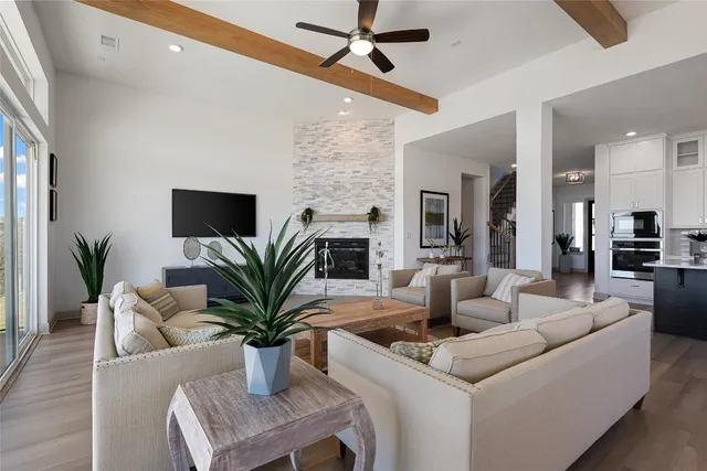 a living room with furniture a flat screen tv and a fireplace