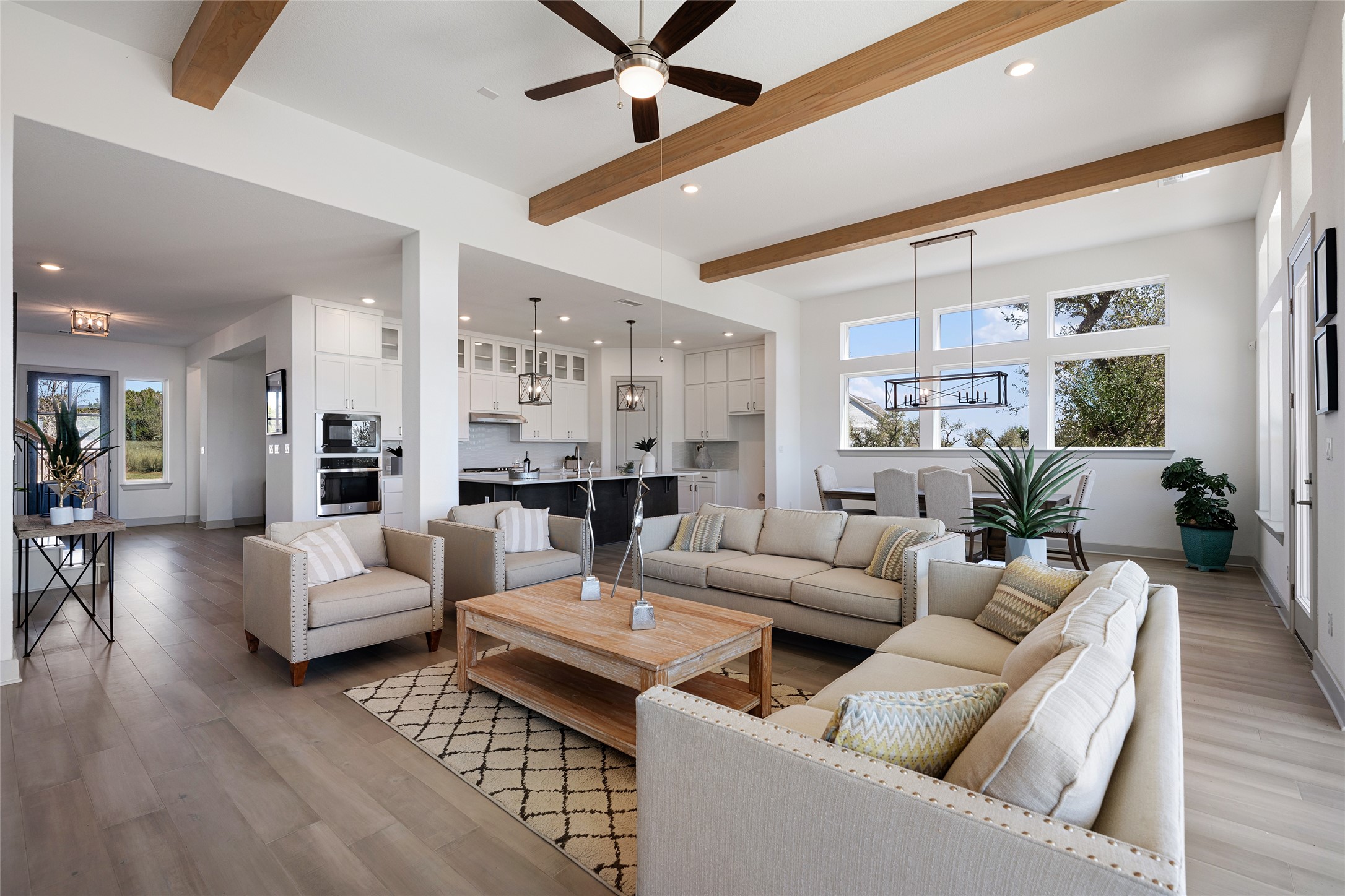 298 Smoke Tree Circle Dripping Springs, TX 78620 - Photo 11 of 38 a living room with furniture kitchen view and a wooden floor