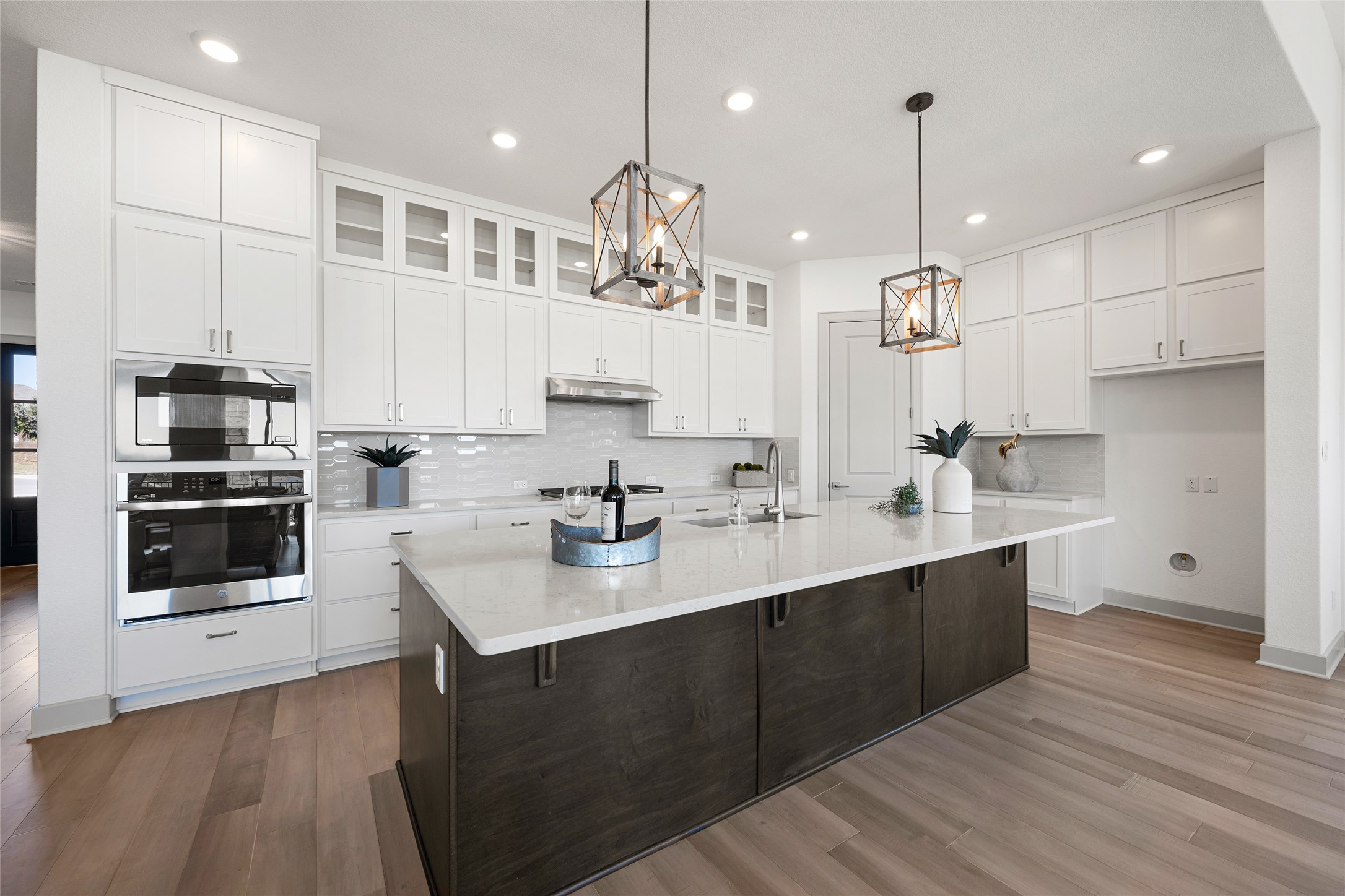 298 Smoke Tree Circle Dripping Springs, TX 78620 - Photo 12 of 38 a kitchen with kitchen island granite countertop a sink a center island stainless steel appliances and cabinets