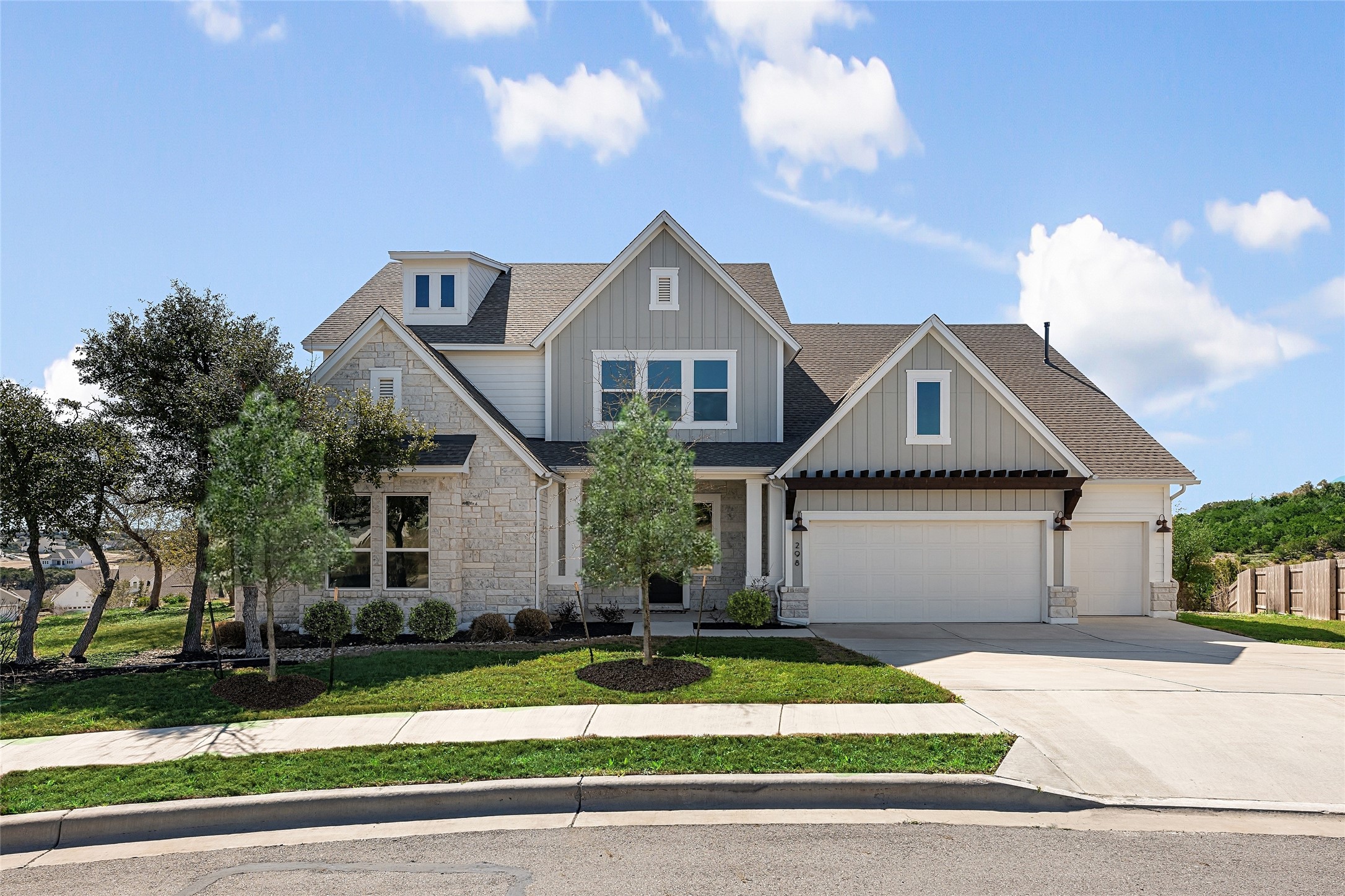 298 Smoke Tree Circle Dripping Springs, TX 78620 - Photo 2 of 38 a front view of a house with a yard