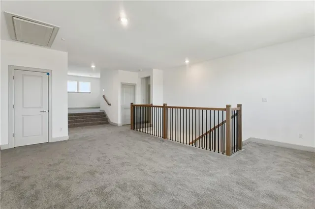 a bathroom with a granite countertop sink a toilet a mirror a bathtub and shower