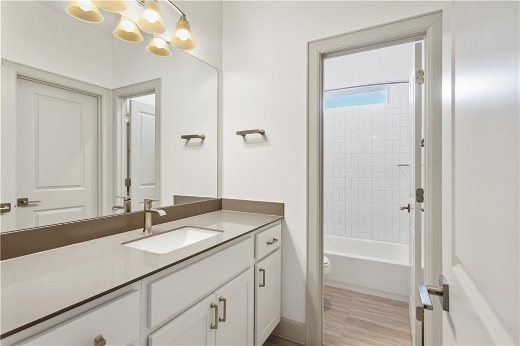 298 Smoke Tree Circle Dripping Springs, TX 78620 - Photo 29 of 38 a bathroom with a sink a vanity and a mirror