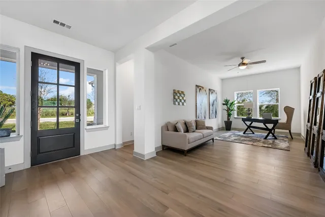a living room with furniture and a large window