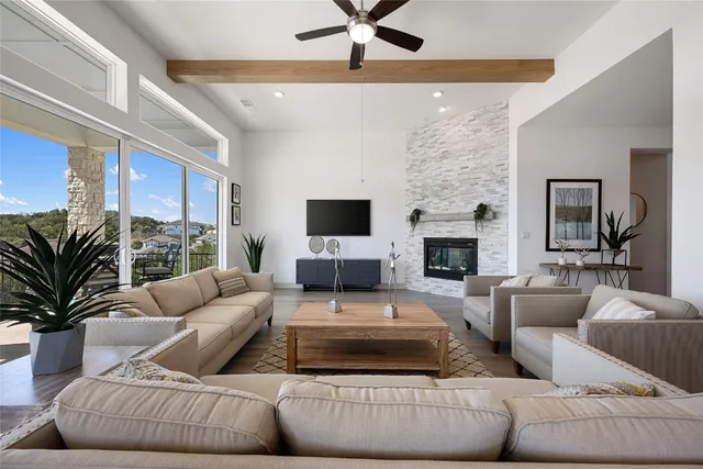 a living room with fireplace furniture and a flat screen tv