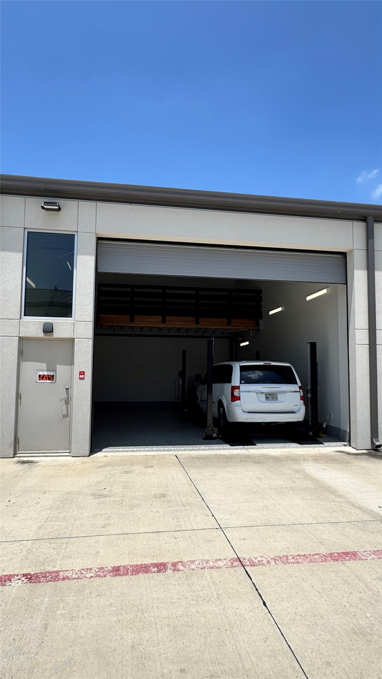1009 Ranch Road 620 North, Unit 401 Lakeway, TX 78734 - Photo 11 of 15 A commercial unit features a spacious garage bay with a rolling door and a convenient man-door entry.