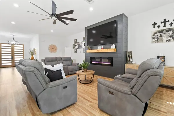 a living room with furniture and a flat screen tv
