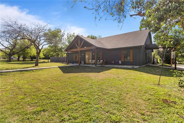 a house view with swimming pool in front of it