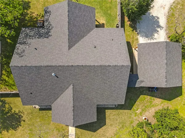 an aerial view of a house with a yard