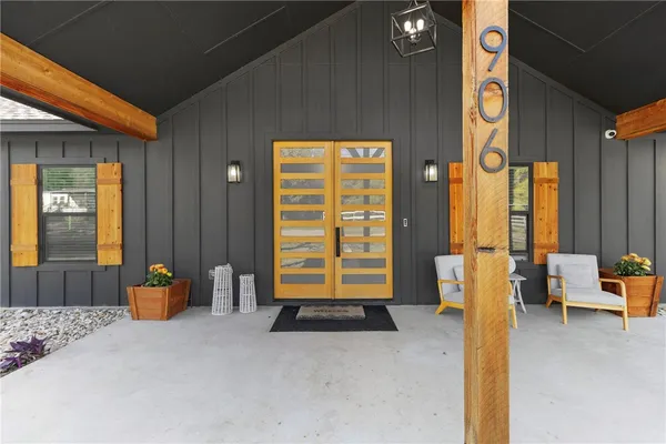 a bedroom with furniture and large windows