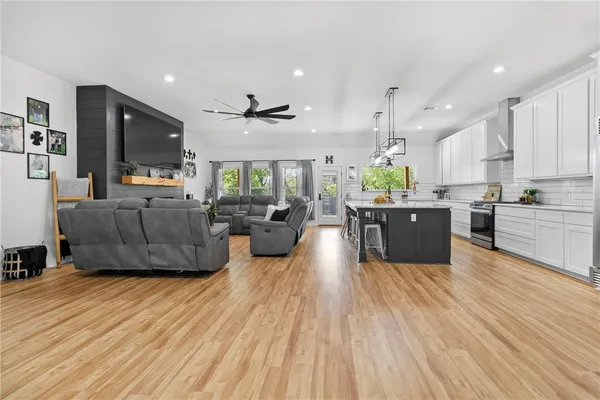 a living room with furniture and a wooden floor