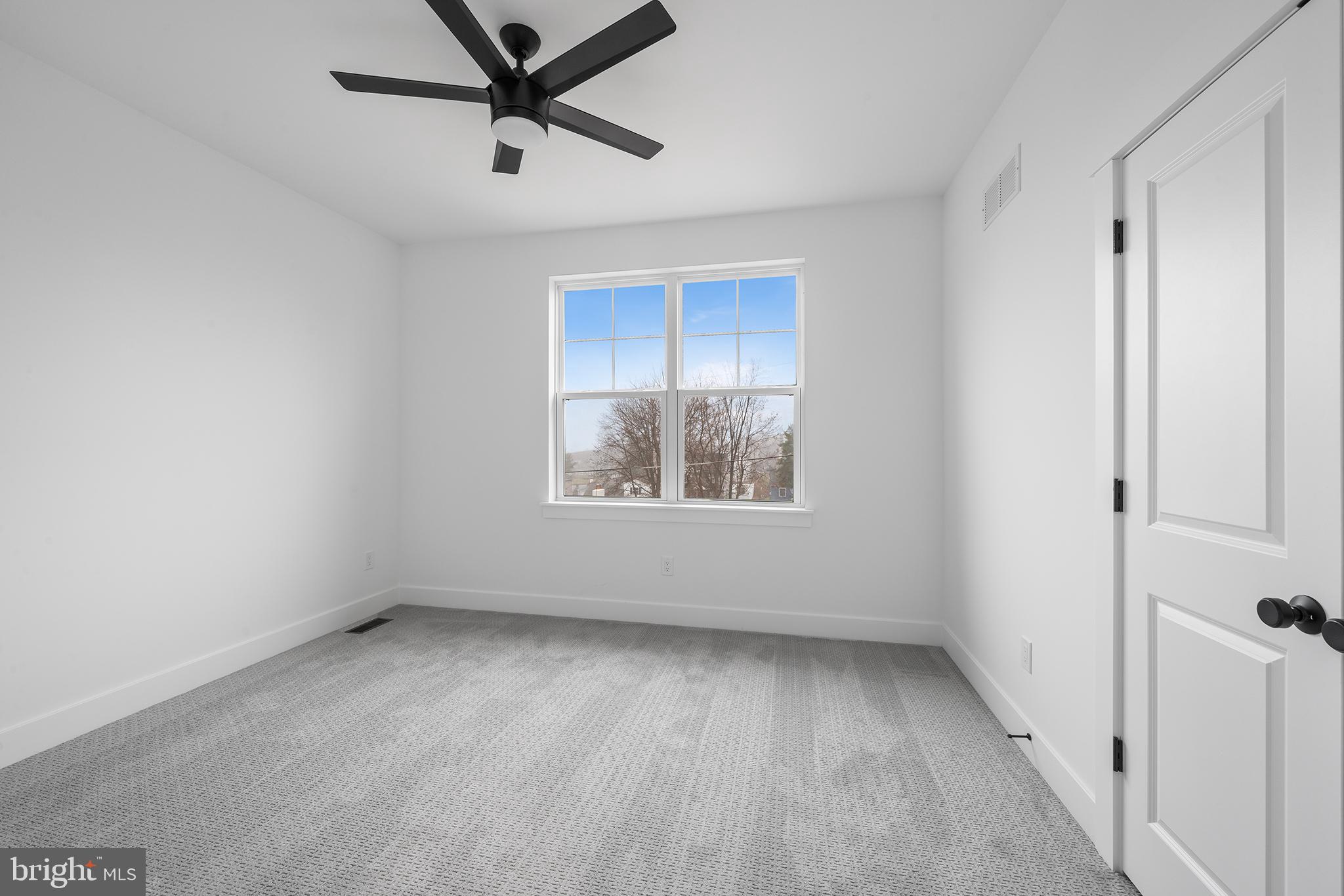 218 Hendricks Avenue Exton, PA 19341 - Photo 27 of 33 an empty room with a window and a ceiling fan