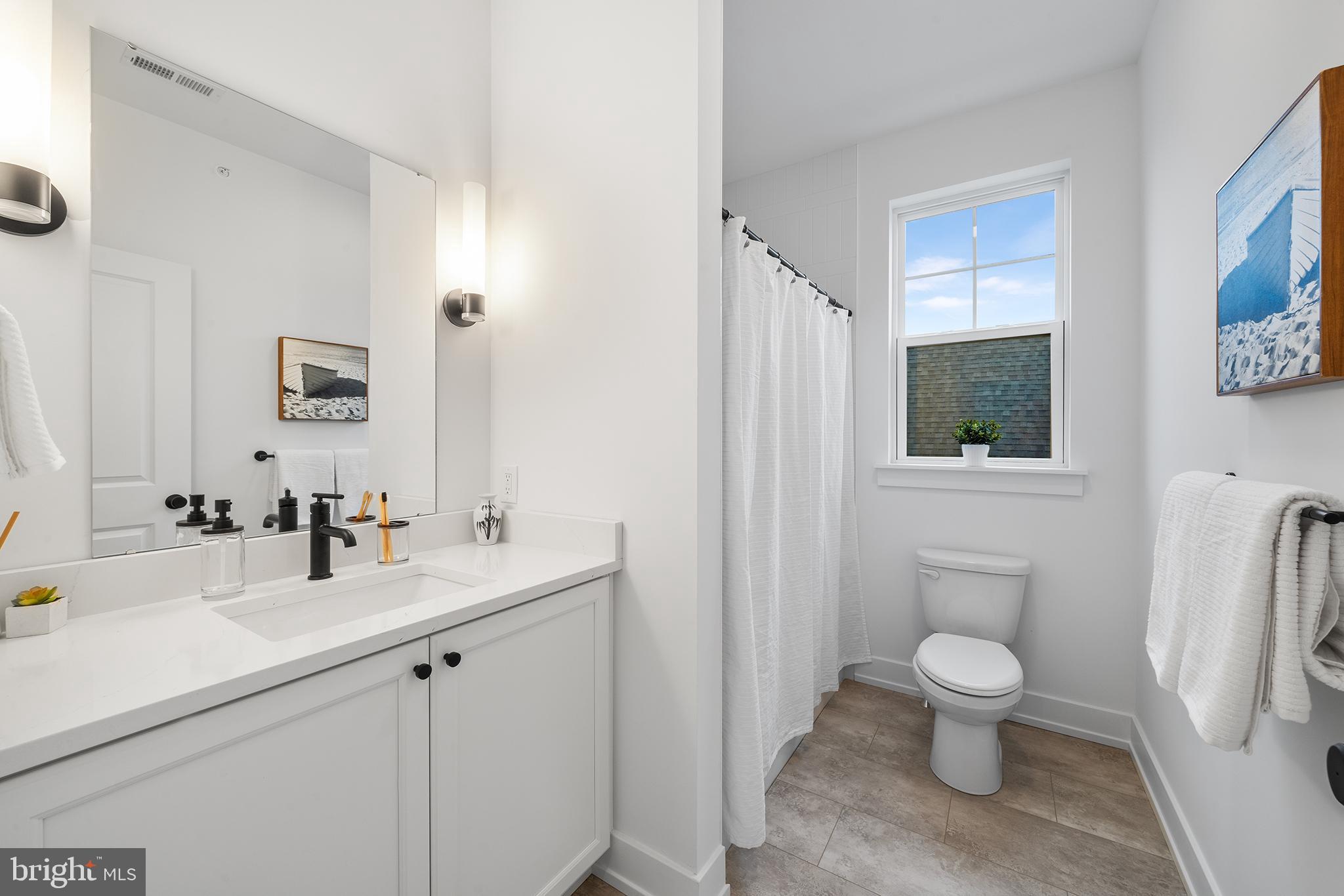 218 Hendricks Avenue Exton, PA 19341 - Photo 29 of 33 a bathroom with a toilet sink and mirror