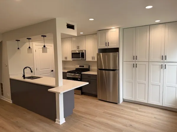 a kitchen with stainless steel appliances a refrigerator and a sink