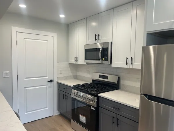 a kitchen with a refrigerator stove and microwave