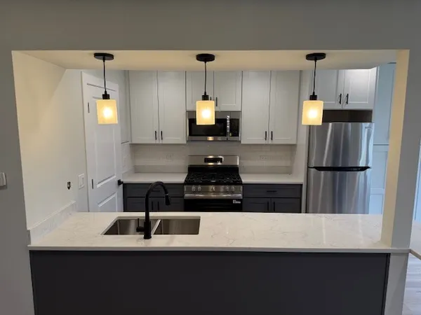 a kitchen with a refrigerator and a stove