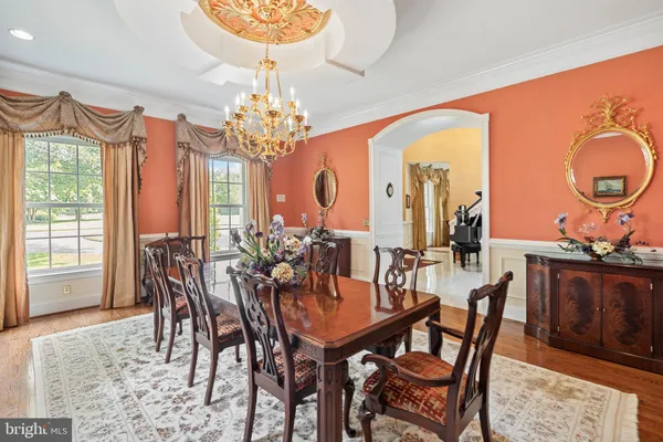 a kitchen with a stove a kitchen island a dining table and chairs with wooden floor