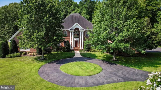 a backyard of a house with a yard and outdoor seating