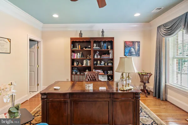 a bedroom with a bed a couch and a chandelier
