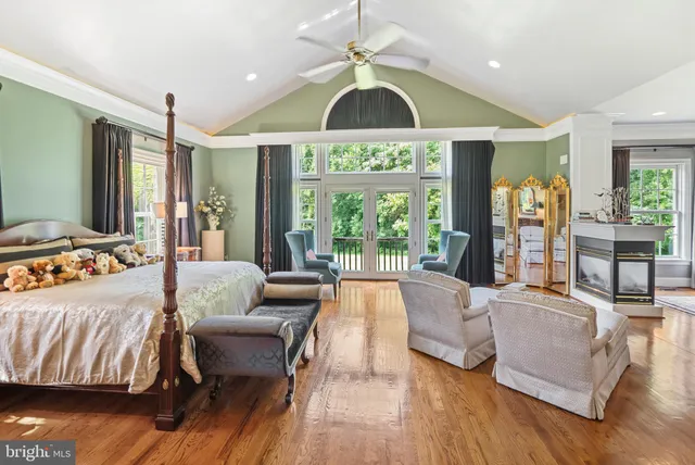 a bed room with a bed mirror and lamp