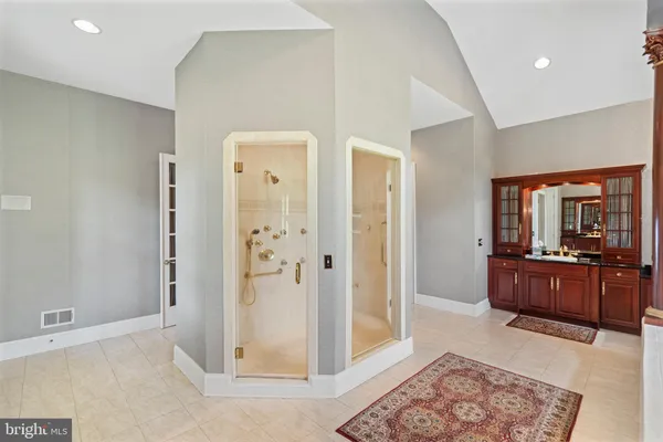 an aerial view of a house with a yard and lake view