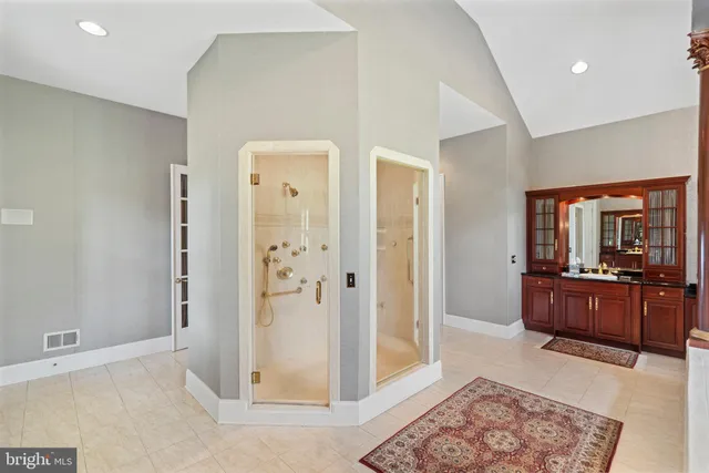 an aerial view of a house with a yard and lake view