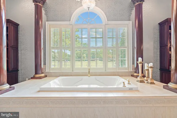 an aerial view of residential house with outdoor space and trees all around