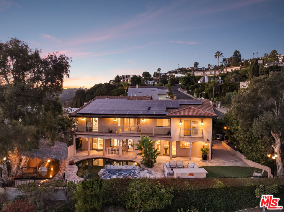 an aerial view of a house with yard swimming pool and outdoor seating