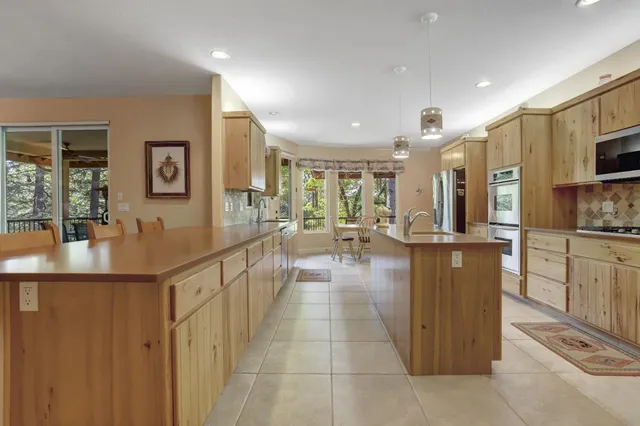 a kitchen with stainless steel appliances white cabinets and a refrigerator
