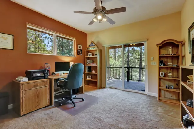 a bedroom with a bed and a flat tv screen on dresser