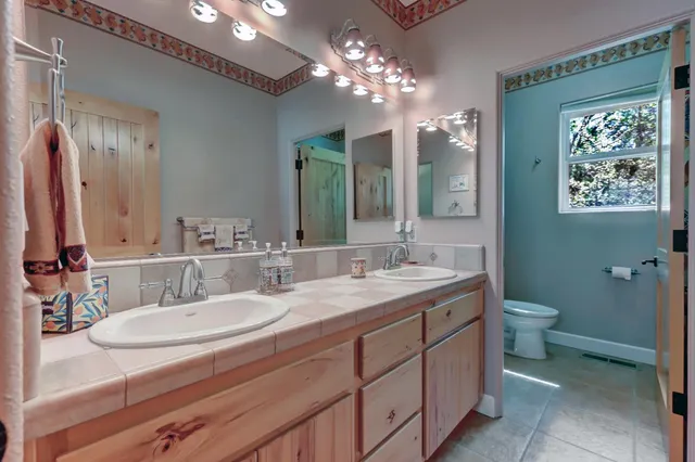 a view of a balcony with chairs and wooden floor
