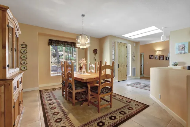 a living room with furniture a large window and a fireplace