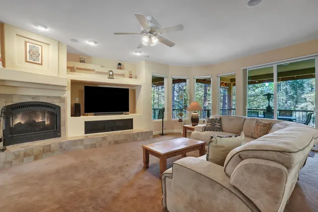 a living room with a fireplace and a flat screen tv