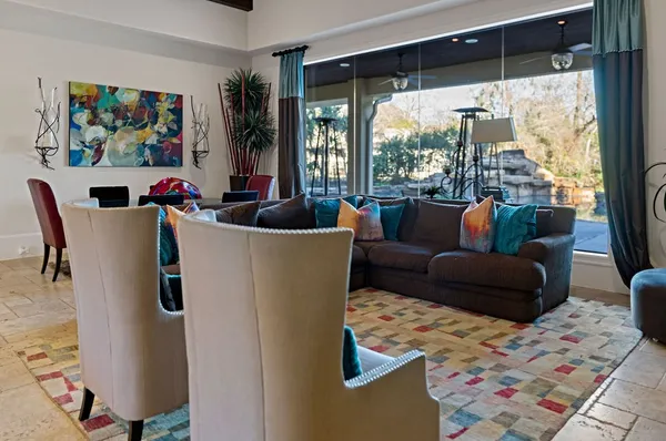 a living room with furniture and a large window