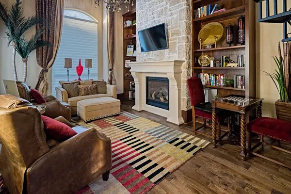 a living room with furniture a flat screen tv and a fireplace