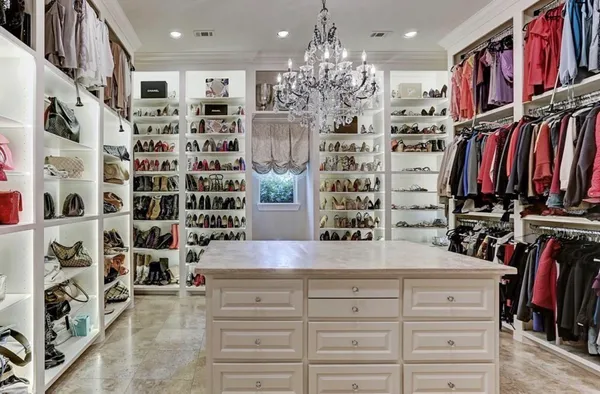 a bed room with a bed furniture and a chandelier