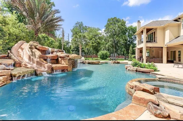 an aerial view of a house with garden space and seating area