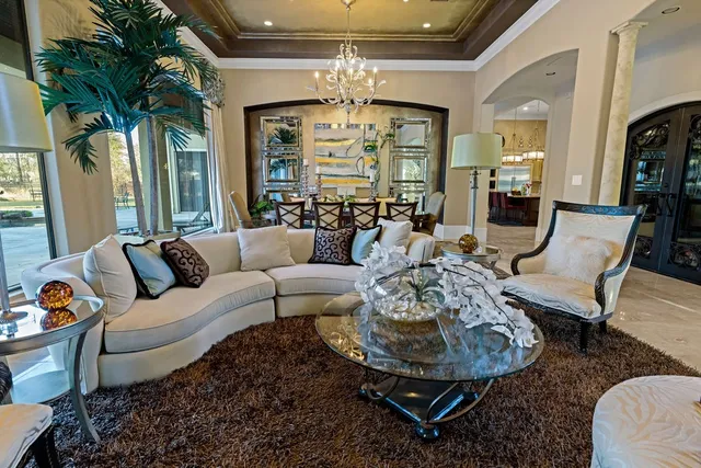 a living room with furniture and a chandelier