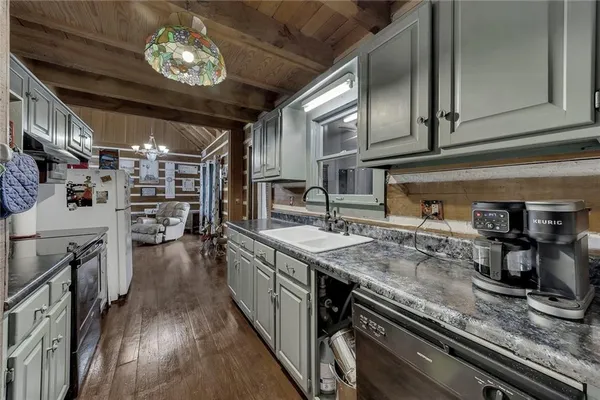 a kitchen with stainless steel appliances granite countertop a sink stove and cabinets