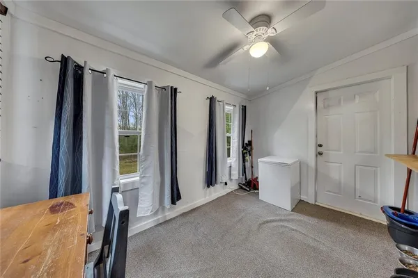 a view of a livingroom with a fireplace and a ceiling fan