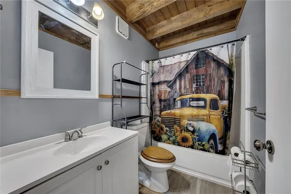 a bathroom with a sink a toilet and a mirror