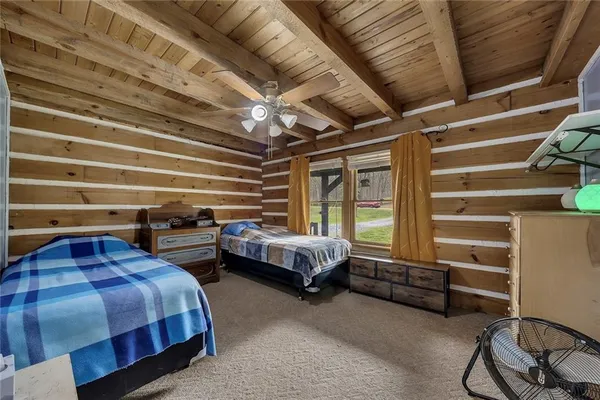 a bedroom with furniture and a window