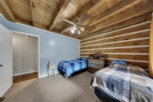 a bedroom with two bed and a chandelier