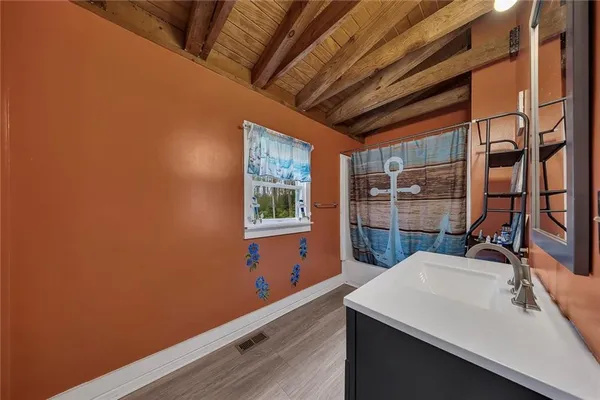 a room with a wooden floor and a sink