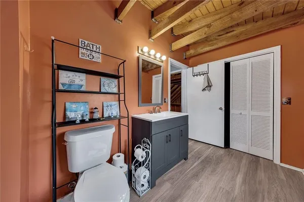 a bathroom with a toilet a sink and mirror